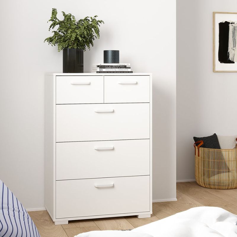 White dresser with drawers in a room with a plant and basket.