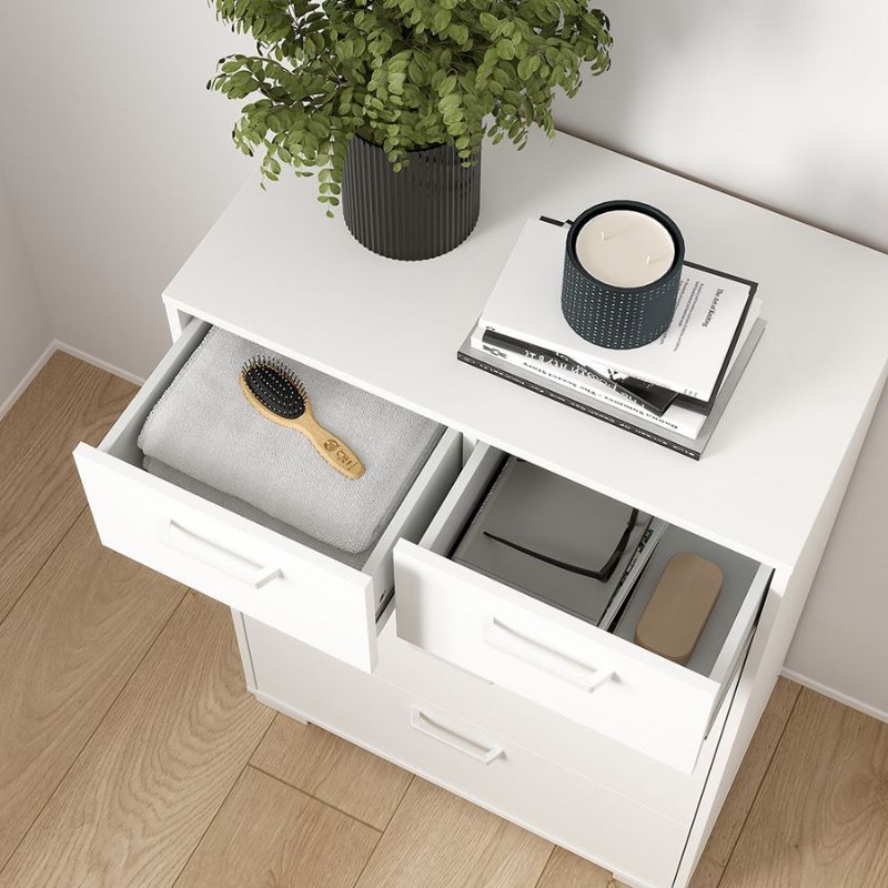 White dresser with open drawers containing a hairbrush, books, and a plant on top.