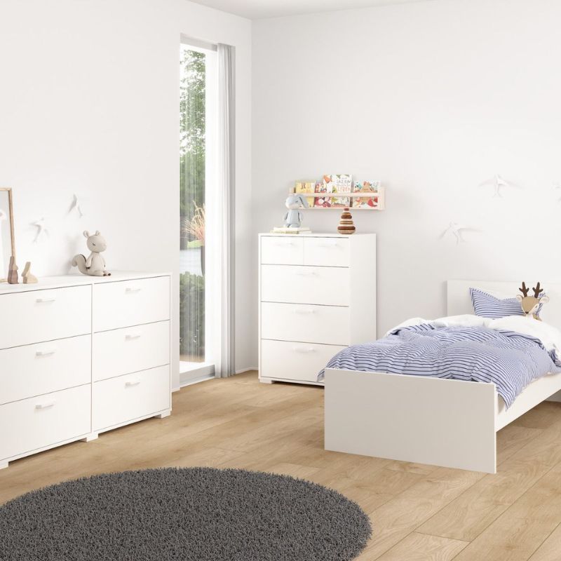 Modern bedroom with white furniture, including a bed and dresser, in a well-lit room.