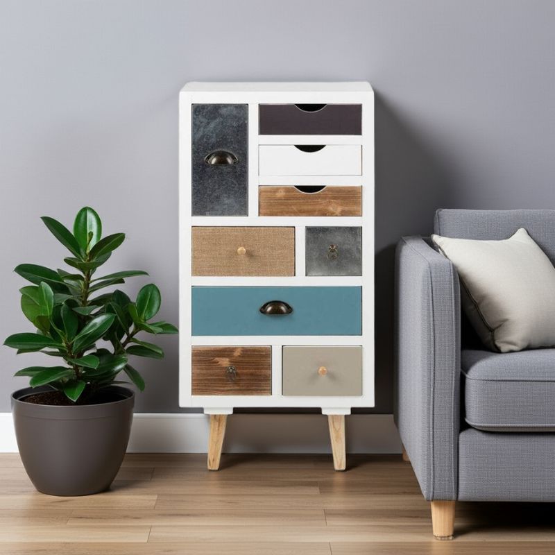 White dresser with multicolored drawers next to a gray sofa and potted plant.
