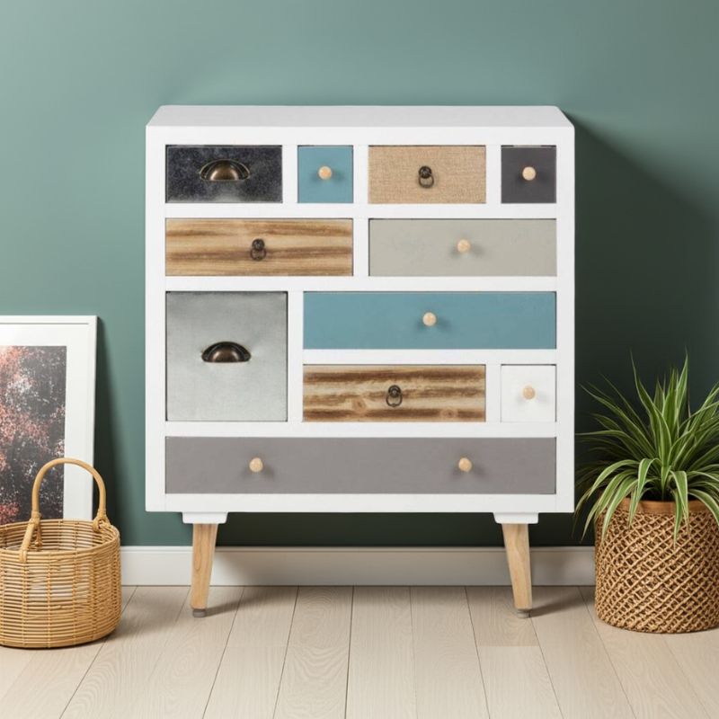 Multicolored drawer cabinet against a green wall with a plant and basket on either side.