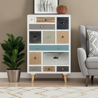 White dresser with multicolored drawers in a living room setting with a plant and sofa.