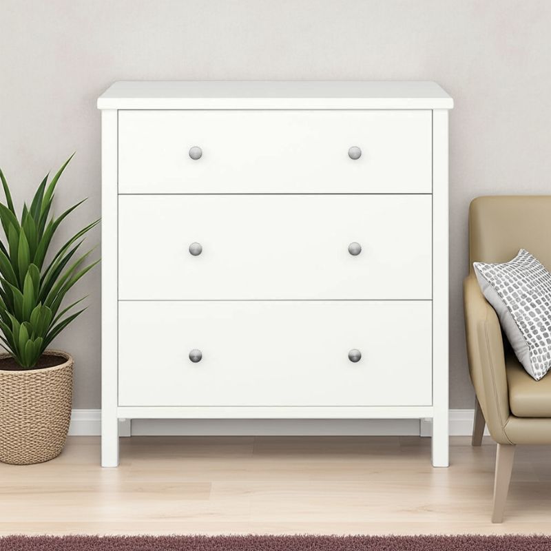 White dresser with three drawers in a room with a plant and chair.