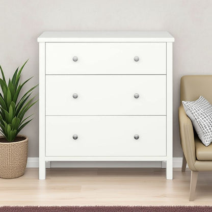White dresser with three drawers in a room with a plant and chair.