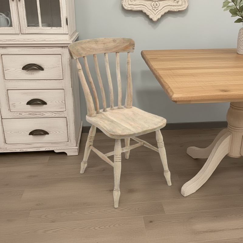 Wooden chair in a room with a table and cabinet.