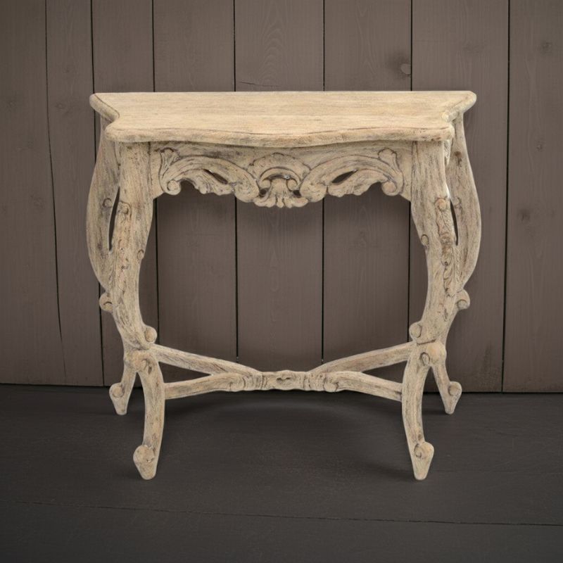 Decorative console table with intricate carvings against a wooden panel background