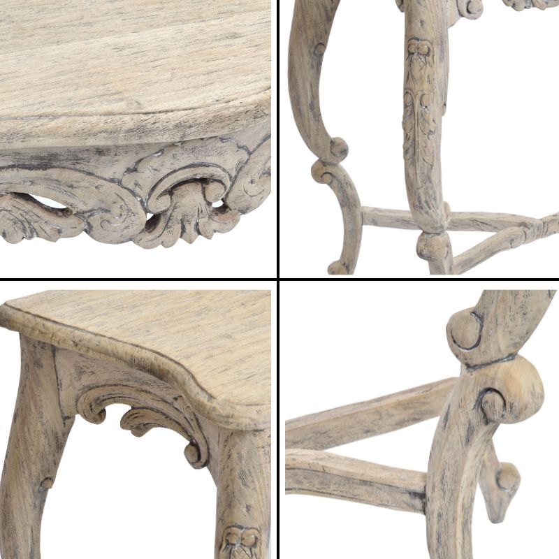 Close-up details of a French styled vintage console table with ornate carvings on a white background