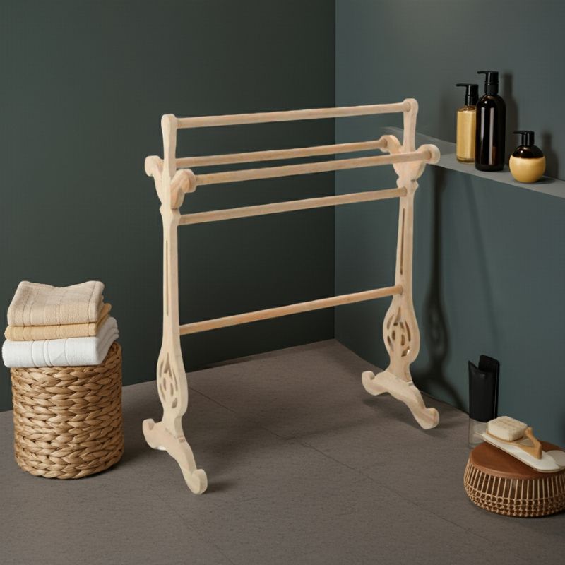 Beige towel rack with folded towels in a basket against a dark wall.