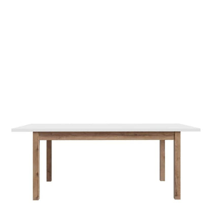 Extending White dining table with wooden legs on a white background
