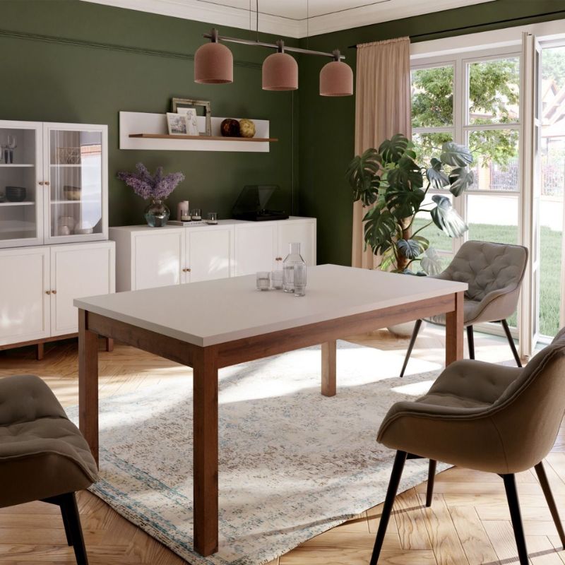 Extending white Dining table in a room with a wooden table, chairs, and a green wall.