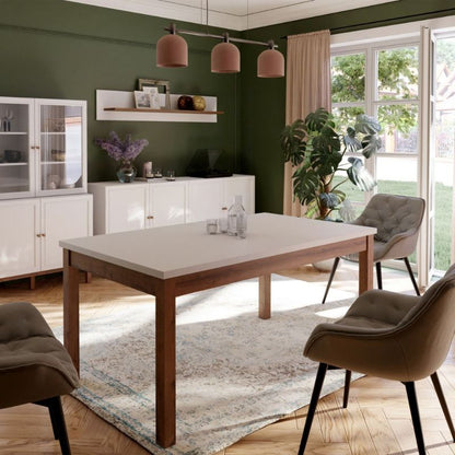 Extending white Dining table in a room with a wooden table, chairs, and a green wall.