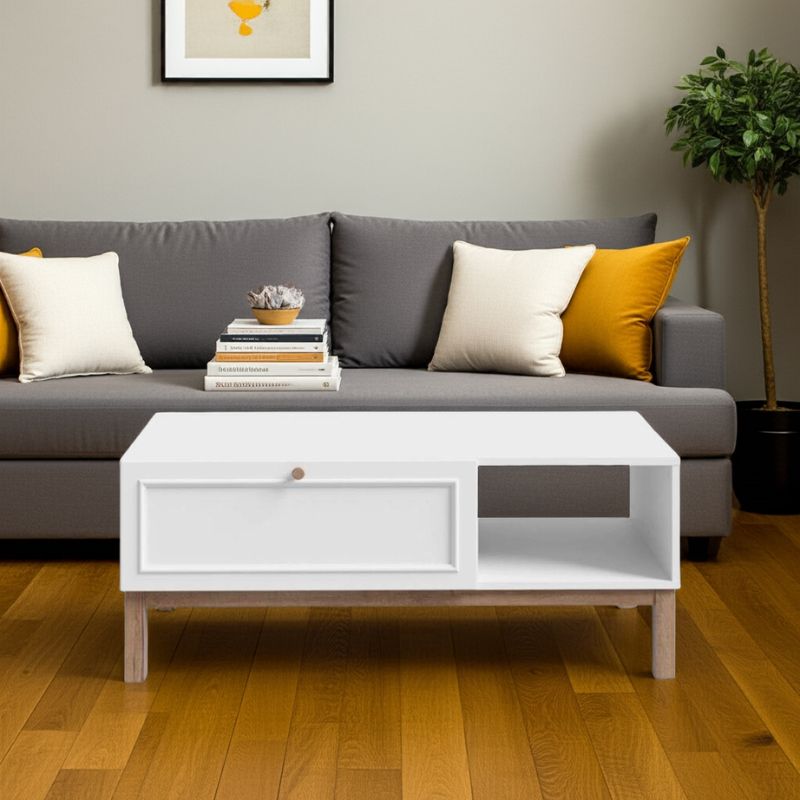 Living room with a gray sofa, white coffee table, and decorative items.