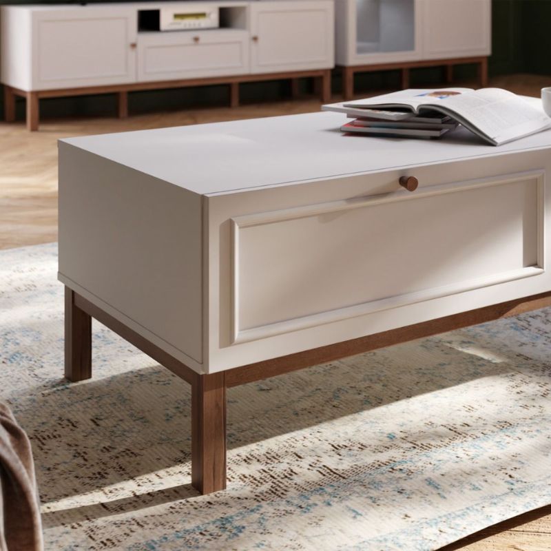 White coffee table with wooden legs in a living room setting