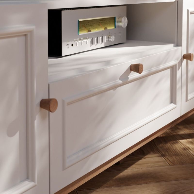 White cabinet with wooden handles and electronic device inside