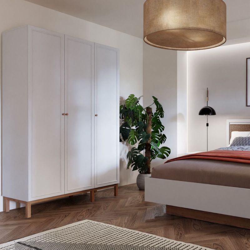 Modern bedroom with white wardrobe, bed, and decorative elements.