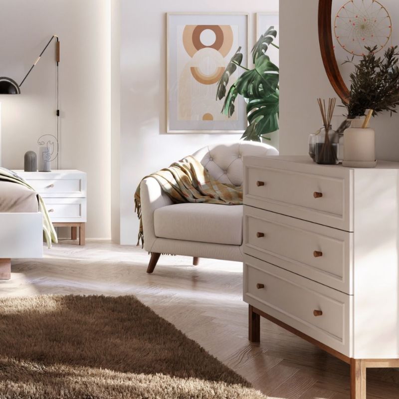 Modern bedroom with a bed, dresser, and wall art