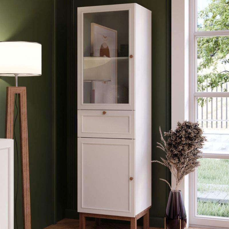 White narrow display cabinet with a single drawer and two doors on a white background