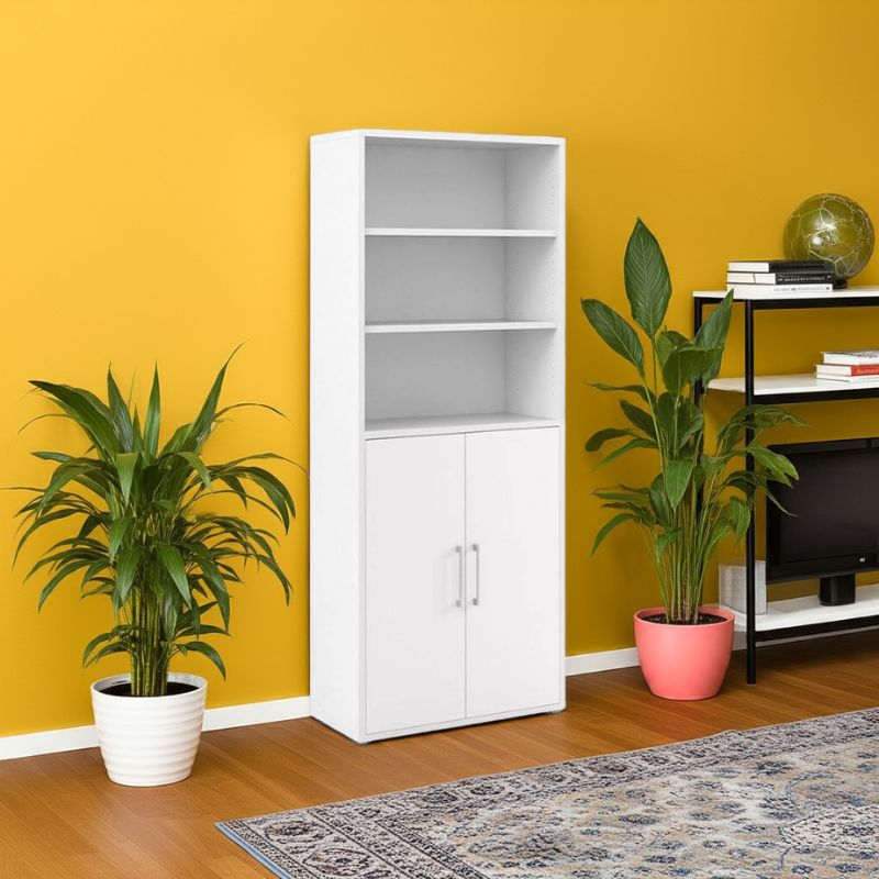 White bookshelf against a yellow wall with plants and a TV stand.