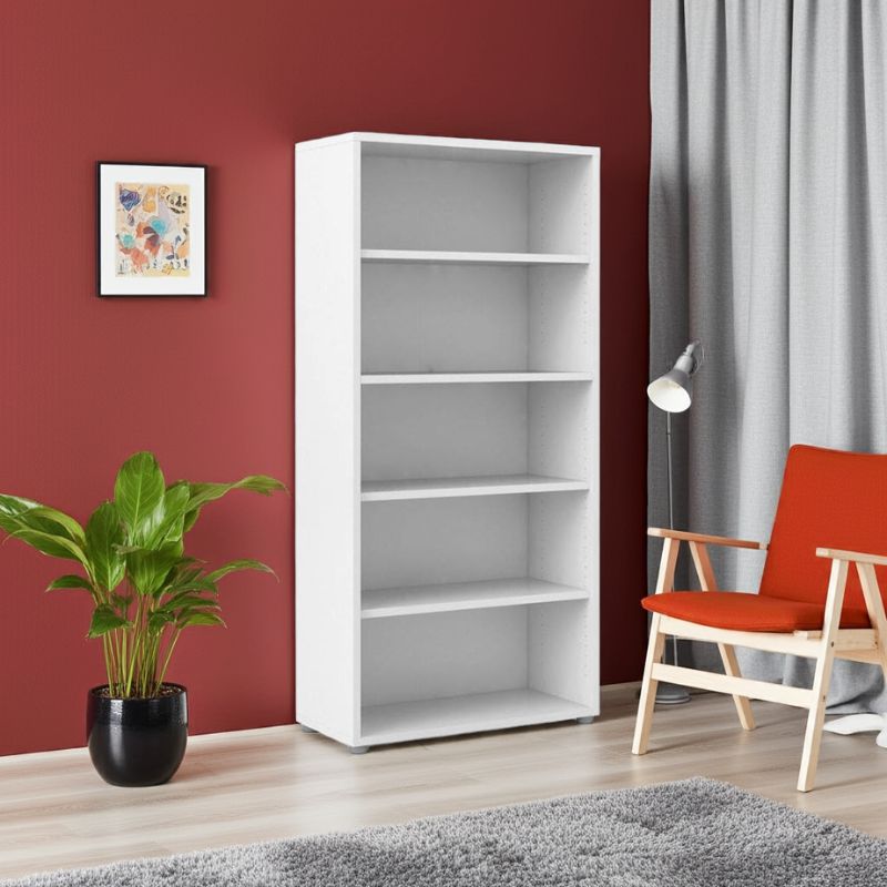 White bookshelf in a room with a red wall, plant, and chair.