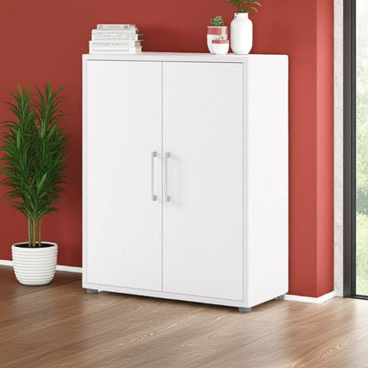 White cabinet with decorative items against a red wall