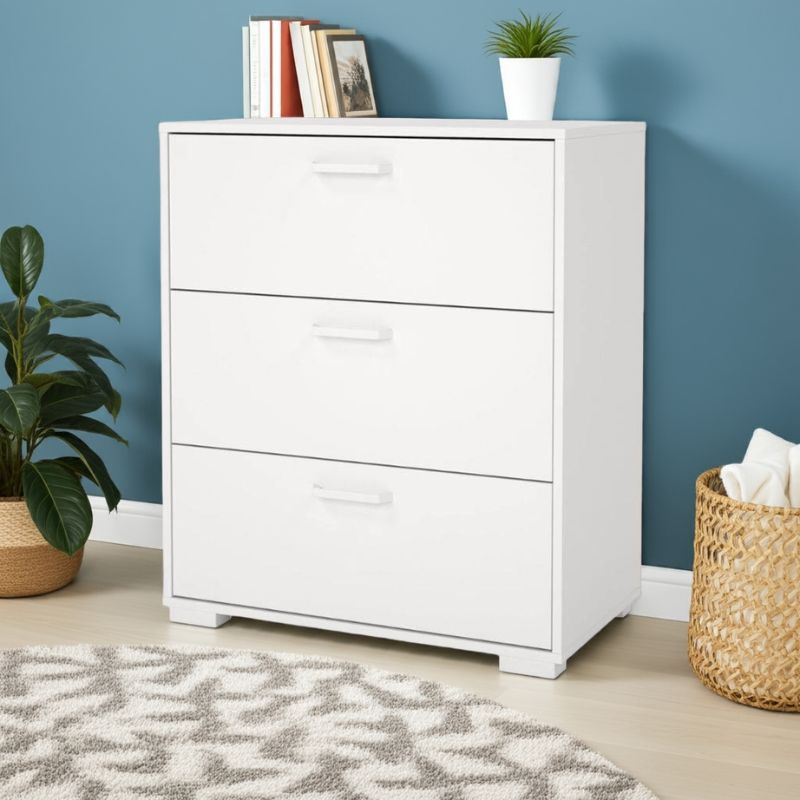 White dresser with three drawers against a blue wall, with a plant and basket on either side.