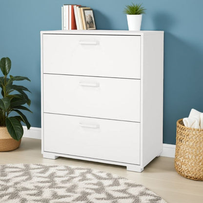 White dresser with three drawers against a blue wall, with a plant and basket on either side.