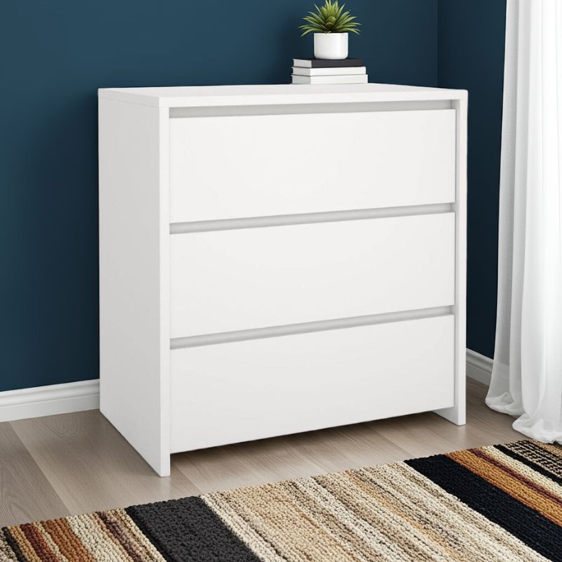 White dresser with decorative items against a blue wall