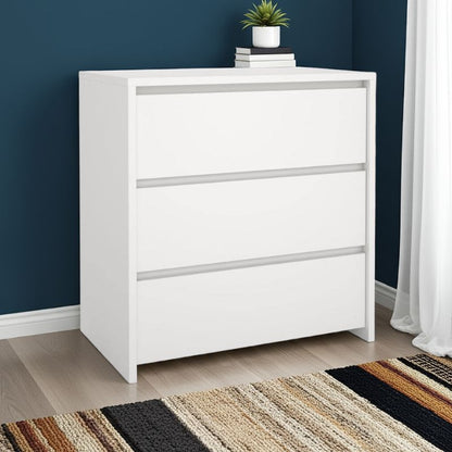 White dresser with decorative items against a blue wall