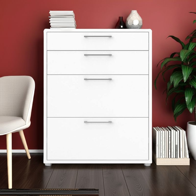 White dresser with three drawers against a red wall, with a chair and plant in the foreground.