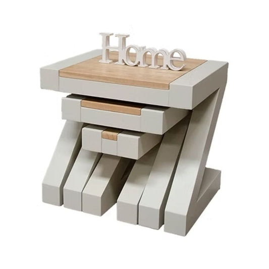 Set of three nesting tables with a wooden top and white base.