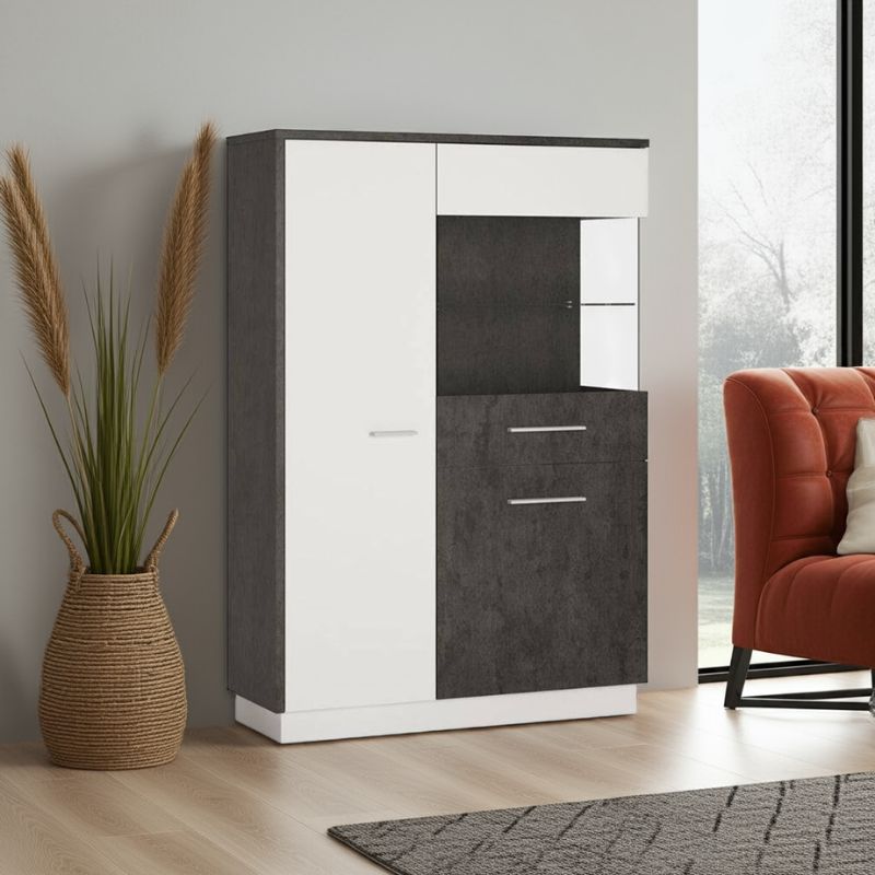 Tall white and black cabinet next to a red armchair and decorative vase in a room with large windows.