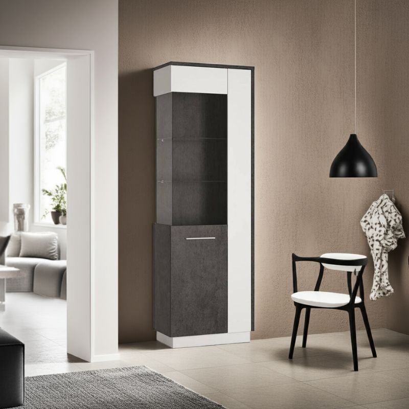 Tall white and black cabinet in a modern living room setting with a chair and lamp.